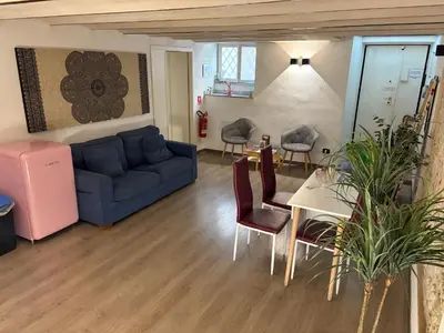a living room with a blue couch and a table at Palermo alla Gancia Room in Palermo