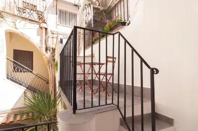 a staircase in a building with a table and chairs at Aragona15 Suites in Palermo