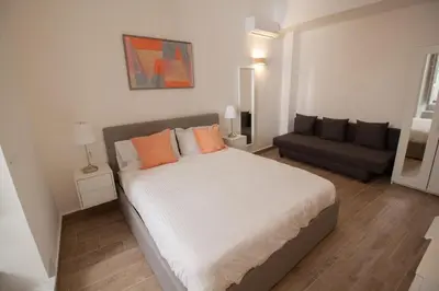 a bedroom with a large bed and a couch at Aragona15 Suites in Palermo
