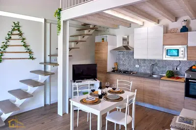 a kitchen and dining room with a white table and chairs at Violisa Charme in Castellammare del Golfo