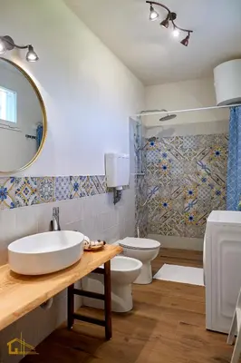 a bathroom with a sink and a toilet and a mirror at Violisa Charme in Castellammare del Golfo