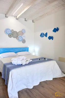 a bedroom with a bed with towels on it at Violisa Charme in Castellammare del Golfo