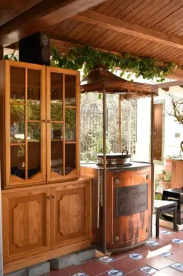 a wooden cabinet with a stove in a patio at Villa Caterina in Torretta
