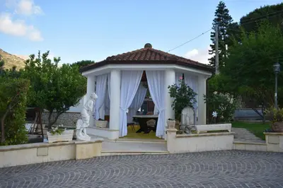a gazebo with a statue in a yard at Villa Caterina in Torretta