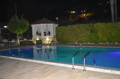 a swimming pool at night with the lights on at Villa Caterina in Torretta