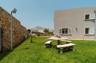 a picnic table in a yard next to a building at Nuova Villa a Scopello con piscina privata in Balata di Baida
