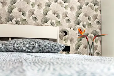 a bedroom with a bed with a floral wallpaper at Case Carà 128, Appartamentini nel cuore di Bagheria, Piano Primo in Bagheria