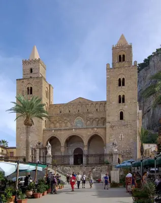 a church with two towers and people walking in front of it at Mansarda Marina in Campofelice di Roccella