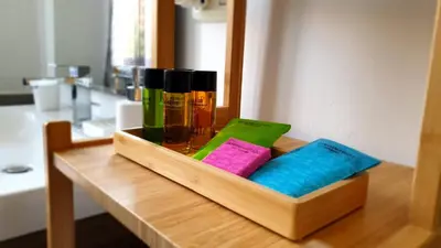 a wooden tray with hair products on a table at Le Vele Mondello, villa a due passi dal mare in Mondello