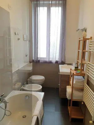 a bathroom with a tub and a toilet and a sink at Le Vele Mondello, villa a due passi dal mare in Mondello
