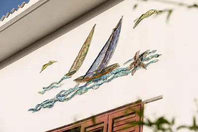 a painting of boats on the side of a building at Le Vele Mondello, villa a due passi dal mare in Mondello
