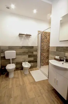 a bathroom with a toilet and a sink at La Casa del Moro - Al Politeama in Palermo