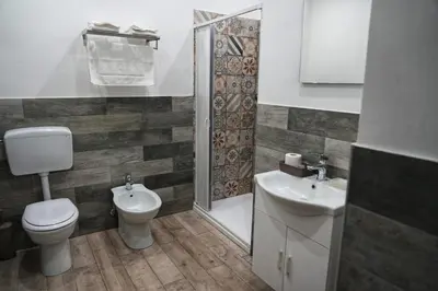 a bathroom with a toilet and a sink and a shower at La Casa del Moro - Al Politeama in Palermo