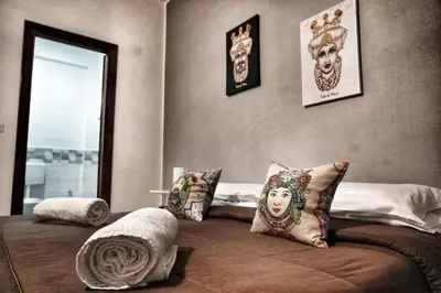 a bedroom with a bed with pillows on it at La Casa del Moro - Al Politeama in Palermo