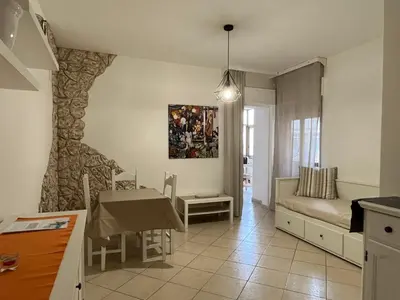 a kitchen and living room with a table and a couch at Dal Porto al Politeama in Palermo