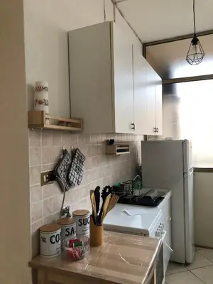 a kitchen with white cabinets and a counter top at Dal Porto al Politeama in Palermo