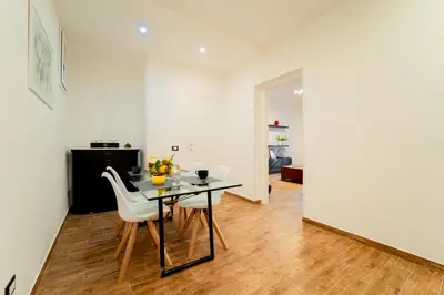 a dining room with a black table and white chairs at Civico64 apartments in Castellammare del Golfo