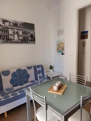a living room with a glass table and a couch at Lovely Apartment in the City Centre in Palermo