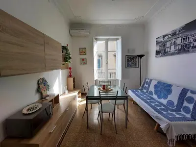 a living room with a table and a couch at Lovely Apartment in the City Centre in Palermo