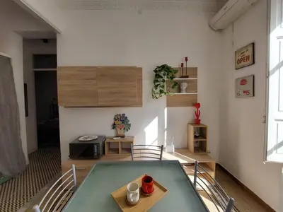 a living room with a glass table and chairs at Lovely Apartment in the City Centre in Palermo