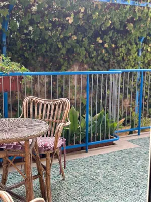a patio with two chairs and a table and a fence at Villa Savoia Mondello in Mondello