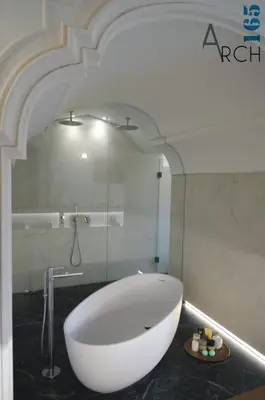 a bathroom with a large white tub and a shower at Le Camere dell’Emiro in Castronuovo di Sicilia