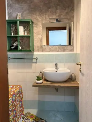 a desk with a television on a table with plants at A casa di Francy in Palermo