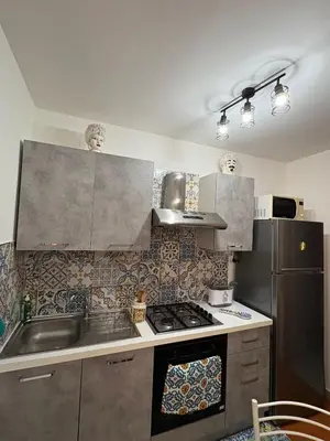 a bedroom with a bed and a cabinet and a chair at A casa di Francy in Palermo
