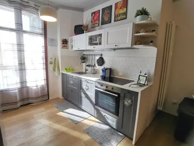 a kitchen with white cabinets and a sink at La casetta al Politeama in Palermo