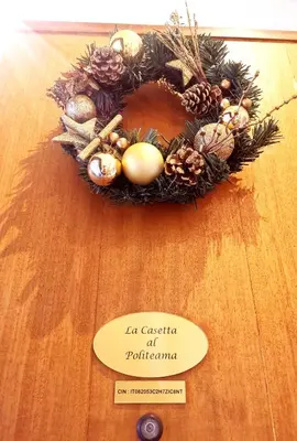 a wreath of christmas decorations on a wooden table at La casetta al Politeama in Palermo