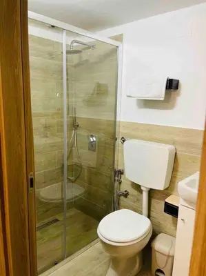 a bathroom with a toilet and a glass shower at Bella Sicilia in Palermo