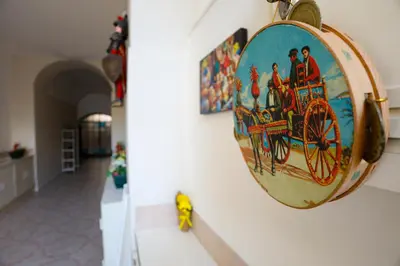 a round mirror on a wall with a painting on it at Bella Sicilia in Palermo