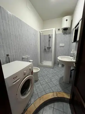 a bathroom with a washing machine and a sink at Casa Ciccio in San Vito lo Capo