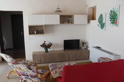 a living room with two chairs and a television at Attico in centro città in Alcamo