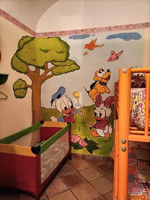 a bedroom with mickey mouse mural on the wall at La Sicilia in casa in Cinisi