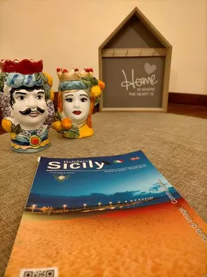 a book sitting on top of a table with two heads at La Sicilia in casa in Cinisi