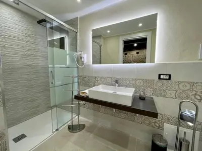 a bathroom with a sink and a mirror at Tommy's rooms in Palermo