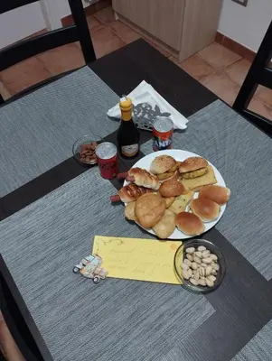 a table with a plate of food and some drinks at Casa vacanza Sole di Sicilia in Palermo