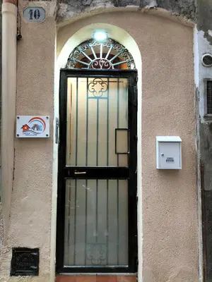 a door to a building with a light on it at Casuzza casa vacanze in Palermo