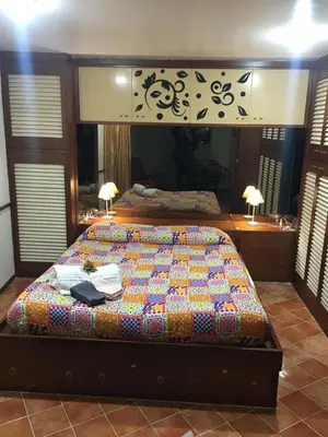 a bedroom with two beds and a large mirror at Casuzza casa vacanze in Palermo