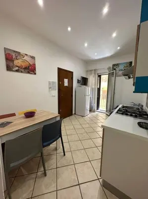 a kitchen with a counter top and a refrigerator at Cusciulìu House in Palermo