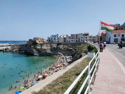 a group of people on a beach in the water at JEY STUDIO_INDEPENDENT SEAFRONT APARTMENT in Terrasini