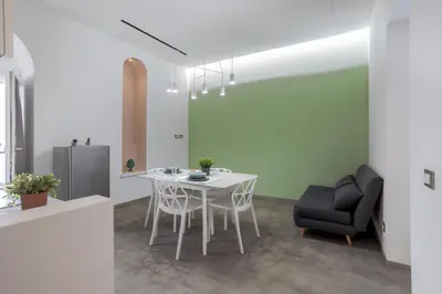 a kitchen with a white table and a black chair at Mag 179 Bed & Spa in Palermo
