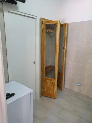 an empty room with a wooden door in a room at Posidonia in Porticello