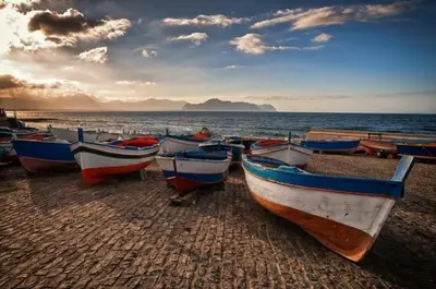 a group of boats sitting on the beach at Terra D'Aspra in Bagheria