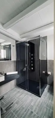 a bathroom with a glass shower and a sink at Havana in Palermo