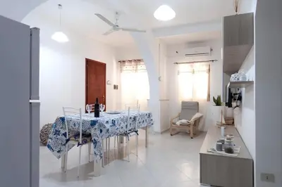 a kitchen and dining room with a table and chairs at Confortevole appartamentino in Castellammare del Golfo