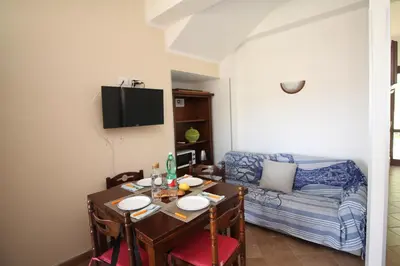 a small living room with a table and a couch at CASA IL LIMONE 300M MARE PARK e GIARDINO PRIV WIFI in San Vito lo Capo