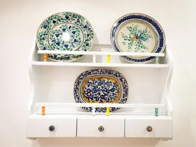 a shelf filled with plates on a wall at Tiski Toski Apartments Palermo in Palermo