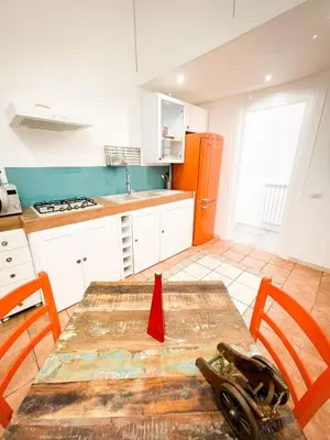 a kitchen with a wooden table with a red ribbon on it at Tiski Toski Apartments Palermo in Palermo